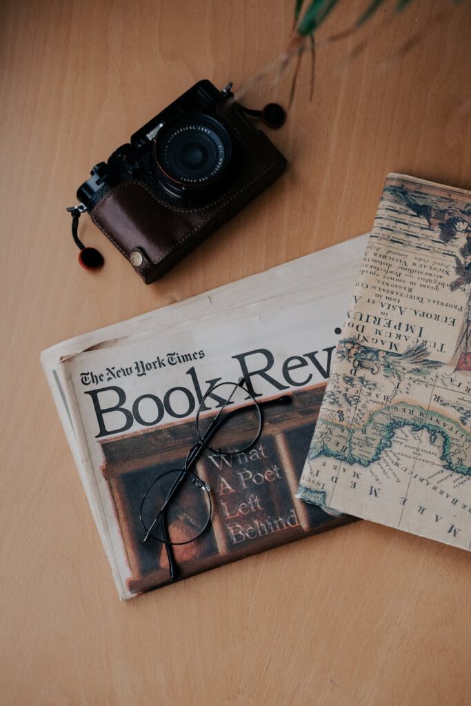 camera and glasses on the newspaper